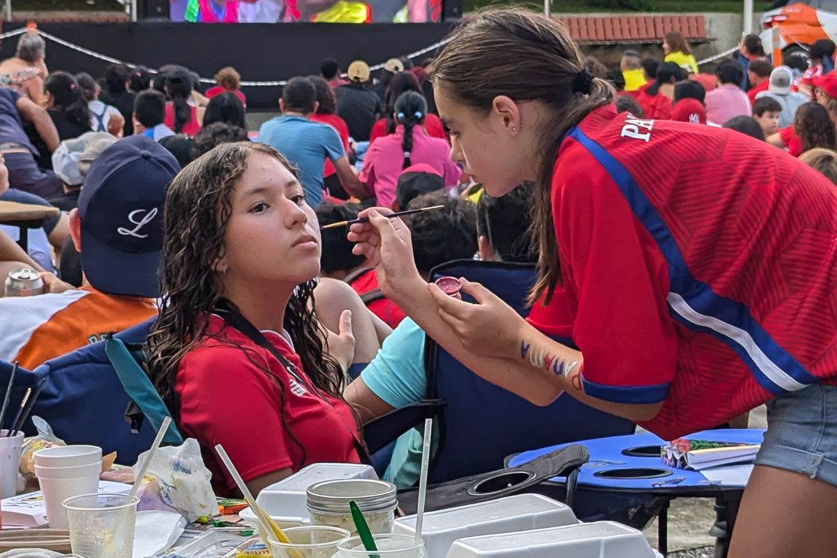 A church member paints the face of a young girl. 